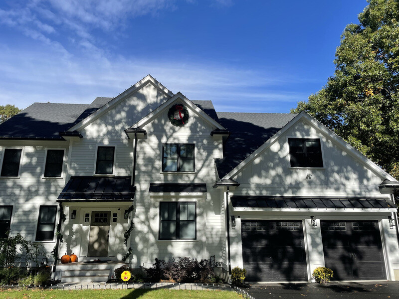 Suburban home in daylight before permanent lighting
